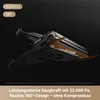A close-up, angled view of a vacuum cleaner head with dirt and debris being picked up. Produktbild-Vorschau