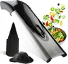 A V-slicer mandoline with a food holder and a bowl of salad in the background. Produktbild-Vorschau