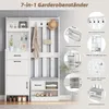 A white entryway organizer with multiple storage compartments and hanging hooks, displayed with illustrative callouts highlighting its features. Podgląd zdjęcia produktu