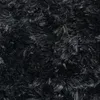 A close-up view of a black shaggy rug. Anteprima dell’immagine prodotto
