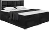 A black upholstered box spring bed with a headboard, two pillows, and a folded blanket. Produktbild-Vorschau