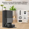 A robot vacuum cleaner and its accessories are displayed on a wooden floor with plants in the background. Voir les images du produit