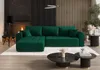 A luxurious green sectional sofa is placed on a plush white rug in a modern living room with a fireplace and wooden accent wall. Náhľad obrázku produktu