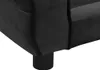 A close-up view of the corner of a black dog sofa, showing the plush fabric and a black cylindrical leg. Náhled obrázku produktu