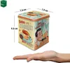 A vintage-style tin box with illustrations and text, shown with a hand for scale. Voir les images du produit