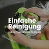 Hands holding a green and black appliance with water splashing. Produktbild-Vorschau