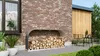 A modern outdoor space with a brick wall, a wooden-clad extension, and a metal firewood rack filled with logs. Produktbild-Vorschau