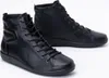 A pair of black leather high-top sneakers on a white background. Produktbild-Vorschau