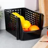 A black plastic storage container filled with fruits, placed on a kitchen counter. Náhled obrázku produktu