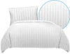 A white duvet cover and pillowcase set with a subtle stripe pattern, presented on a white background. Produktbild-Vorschau