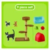 A collection of cat toys and figurines arranged on a green background. Anteprima dell’immagine prodotto