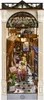 A miniature diorama of a book nook, resembling a charming Parisian street scene with a cafe and bookstore. Podgląd zdjęcia produktu