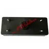 A black rectangular object with metal studs and a central circular opening is displayed against a white background. Voir les images du produit
