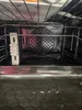 Close-up view inside an oven, showing the heating element and racks. Produktbild-Vorschau
