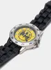 A close-up, angled view of a Batman-themed watch with a black rubber strap and a yellow dial. Náhľad obrázku produktu