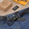 A black leather belt is laid across a pair of blue jeans, with a TRESSARI branded box and tag nearby. Produktbild-Vorschau