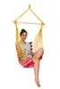 A woman is sitting in a colorful hammock chair. Produktbild-Vorschau