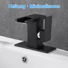 A black waterfall faucet is installed on a white sink. Produktbild-Vorschau