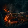 A close-up shot of a grill with steaks and sausages being cooked over flames. Podgląd zdjęcia produktu
