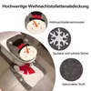 A Christmas-themed toilet seat cover and bath mat set featuring a snowman design, displayed on a toilet and floor. Anteprima dell’immagine prodotto