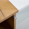A close-up of furniture, showing a wood surface meeting a white surface with a drawer handle visible. Produktbild-Vorschau