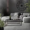 A modern living room with a gray sectional sofa, a black coffee table, and a large wall clock. Náhľad obrázku produktu