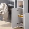 A white cabinet with open doors, revealing shelves with toiletries and towels. A towel is draped over a rack in the background. Voir les images du produit