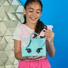 A young girl is holding a toy purse that looks like a puppy dog. Náhľad obrázku produktu