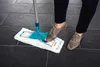 A person is using a mop to clean a tiled floor. Produktbild-Vorschau