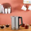 A kitchen counter scene with a kettle and cups. Voir les images du produit