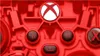 A close-up, detailed view of a red Xbox wireless controller, focusing on the central buttons and the Xbox logo. Podgląd zdjęcia produktu