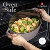 A person is placing a pot of food into an oven. Náhľad obrázku produktu