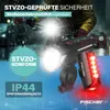 A bicycle light set is shown mounted on a bicycle handlebar in a rainy environment. Náhľad obrázku produktu
