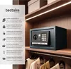 A safe is placed on a shelf in a closet, with clothes hanging below. Produktbild-Vorschau