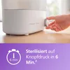 A close-up of a hand turning a dial on a Philips Avent baby bottle sterilizer, with a graphic overlay showing a timer and text. Produktbild-Vorschau
