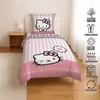 A Hello Kitty themed bed set on a bed in a bedroom. Produktbild-Vorschau