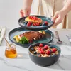A person is serving a plate of food, with other plates and a bowl of cereal on a table. Náhled obrázku produktu