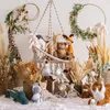 A collection of stuffed animals arranged in a nursery-like setting with decorative elements. Produktbild-Vorschau