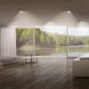 A modern living room with large windows overlooking a lake and forest. Produktbild-Vorschau