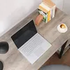 A laptop, books, and a cup of coffee are arranged on a wooden desk. Náhled obrázku produktu