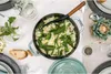 A table setting with a pot of risotto and bread. Produktbild-Vorschau