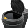 Close-up view of the top of two black trash bins, one with its lid open. Voir les images du produit