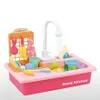 A toy sink with accessories, including dishes, cups, and cleaning supplies, set against a white background. Náhled obrázku produktu