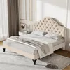 A tufted beige bed in a well-lit room with decorative wall paneling. Produktbild-Vorschau