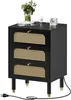A black nightstand with rattan drawer fronts and gold accents, shown on a white background. Voir les images du produit