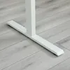 Close-up of the white base of a standing desk on a light gray wood-look floor. Voir les images du produit