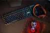 A gaming keyboard, mouse, and headset are arranged on a dark surface. Náhled obrázku produktu