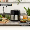 A kitchen counter with an air fryer, fresh vegetables, and prepared food. Produktbild-Vorschau