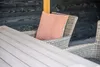 A close-up of an outdoor table and chairs with a patterned cushion. Produktbild-Vorschau