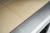 A close-up view of a pizza oven's cooking surface and metal trim. Produktbild-Vorschau